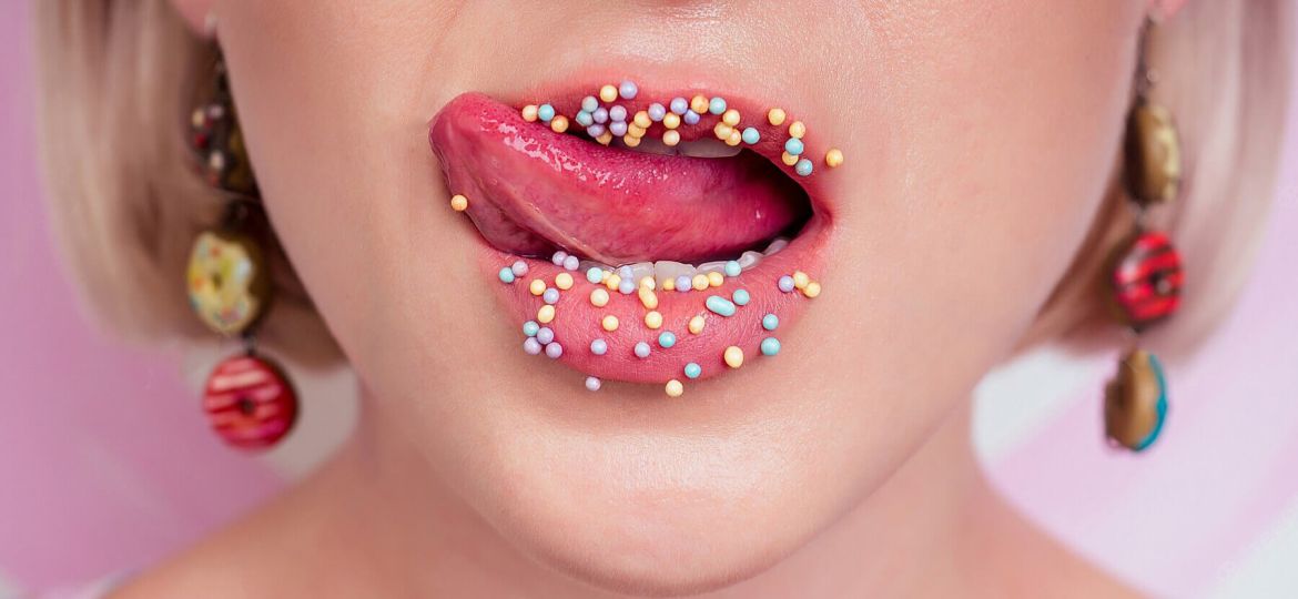 portrait-beautiful-blonde-barbie-woman-perfect-makeup-tongue-sexy-licking-lip-donuts-earrings